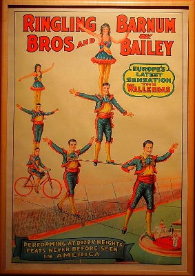 [Ringling Bros and Barnum & Bailey poster showing performers stacked several high crossing on a high-wire.]